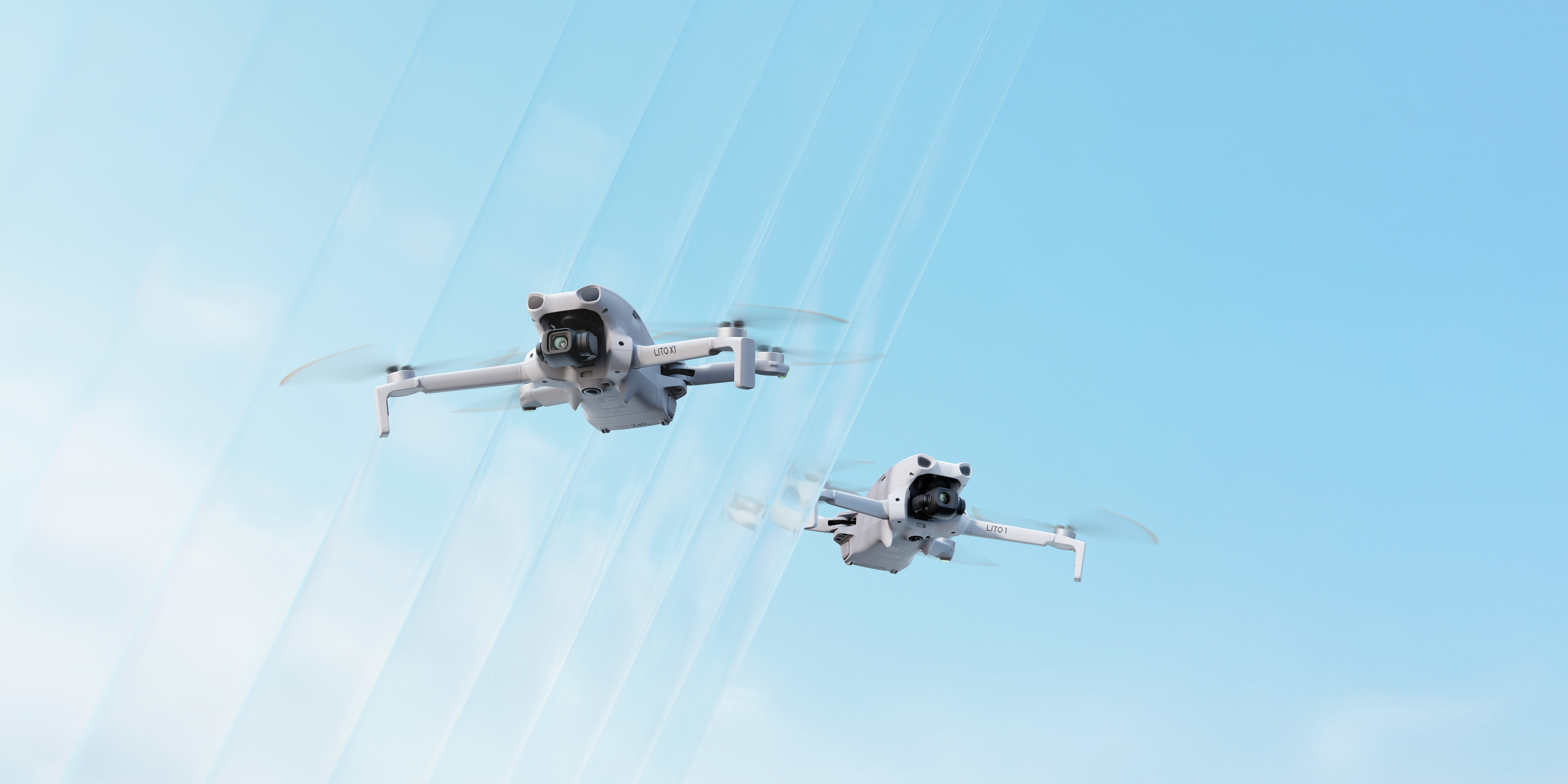 DJI Lito Serie Drohne – schräge Vorderansicht im Flug mit Kamera und ausgeklappten Rotorarmen vor hellem Hintergrund