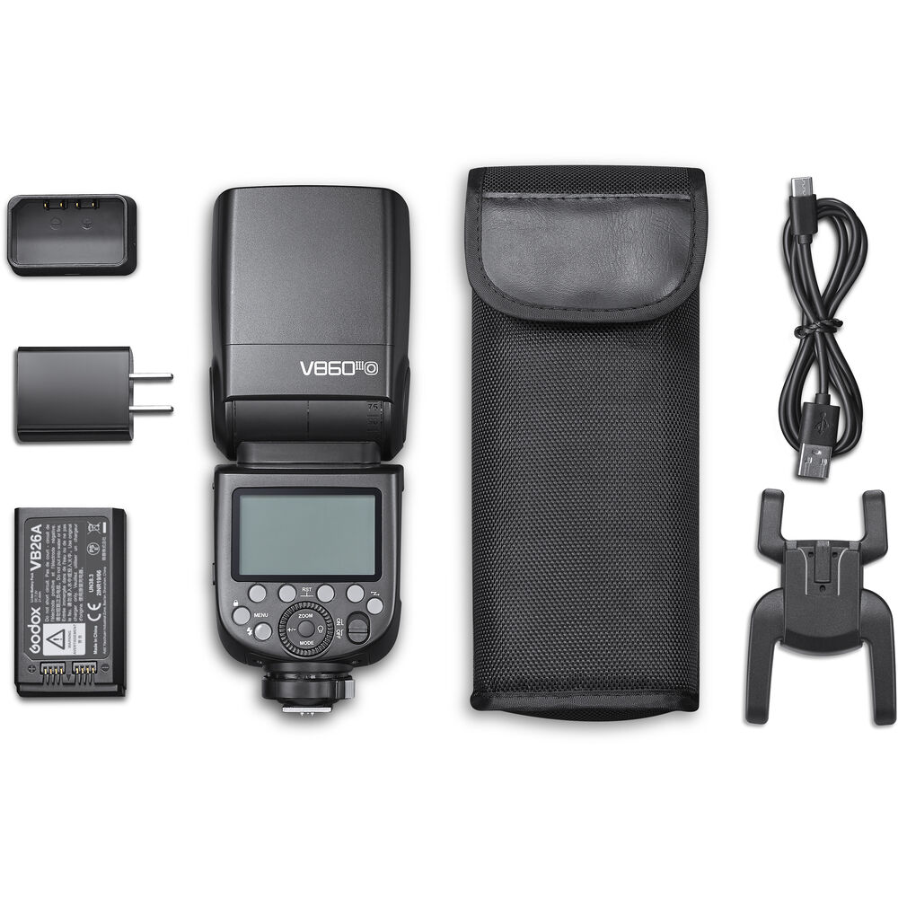 Lieferumfang des Godox V860III Speedlite für OM SYSTEM und Panasonic mit Akku, Ladegerät, Tasche und Standfuß.