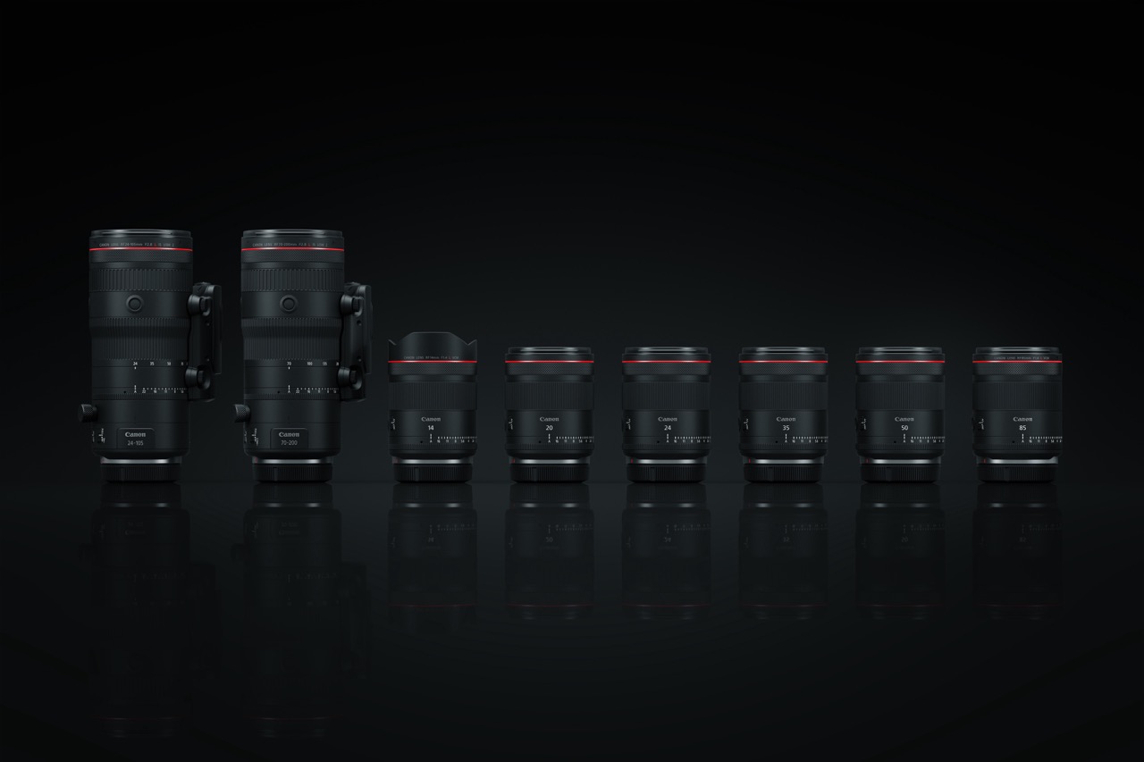 Canon RF Hybrid-Objektive der L-Serie – frontal aufgereihte Zoom- und Festbrennweiten vor dunklem Studiohintergrund